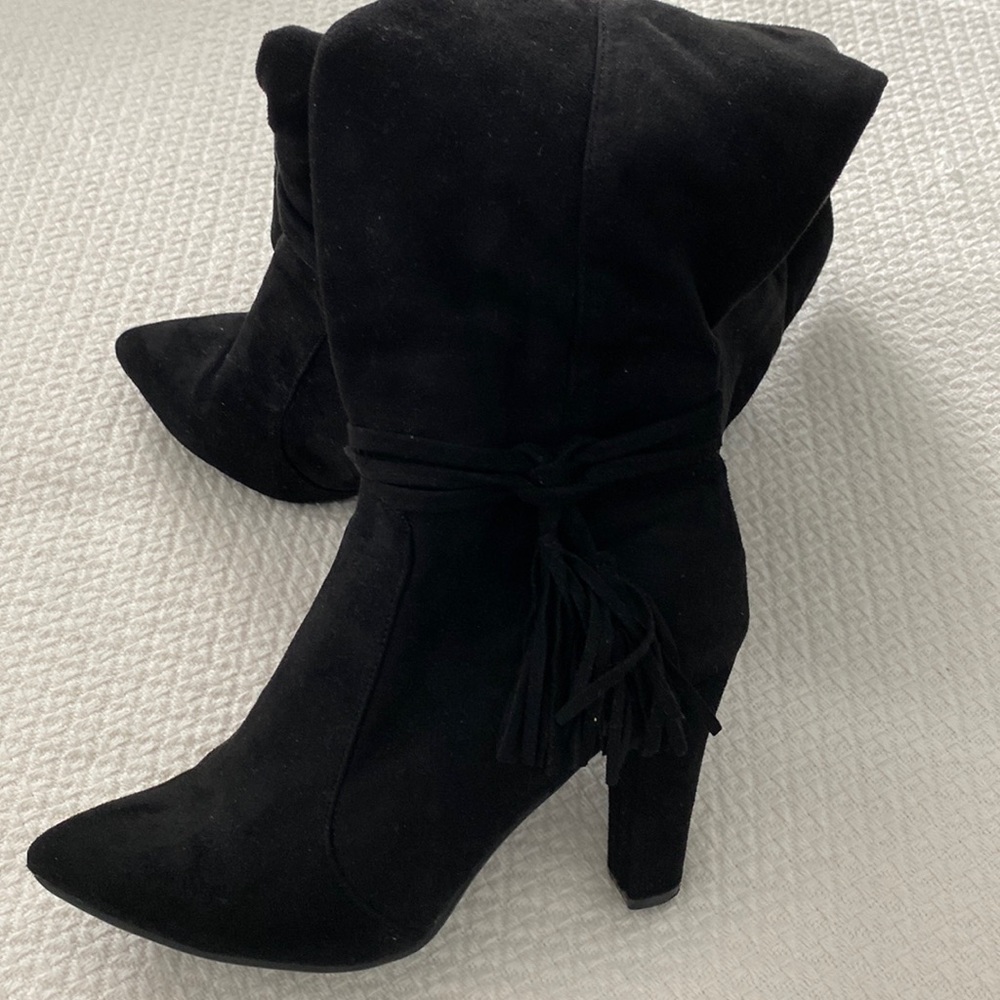 Black micro suede knee high boots. Side zip. Tassel detail at ankle.